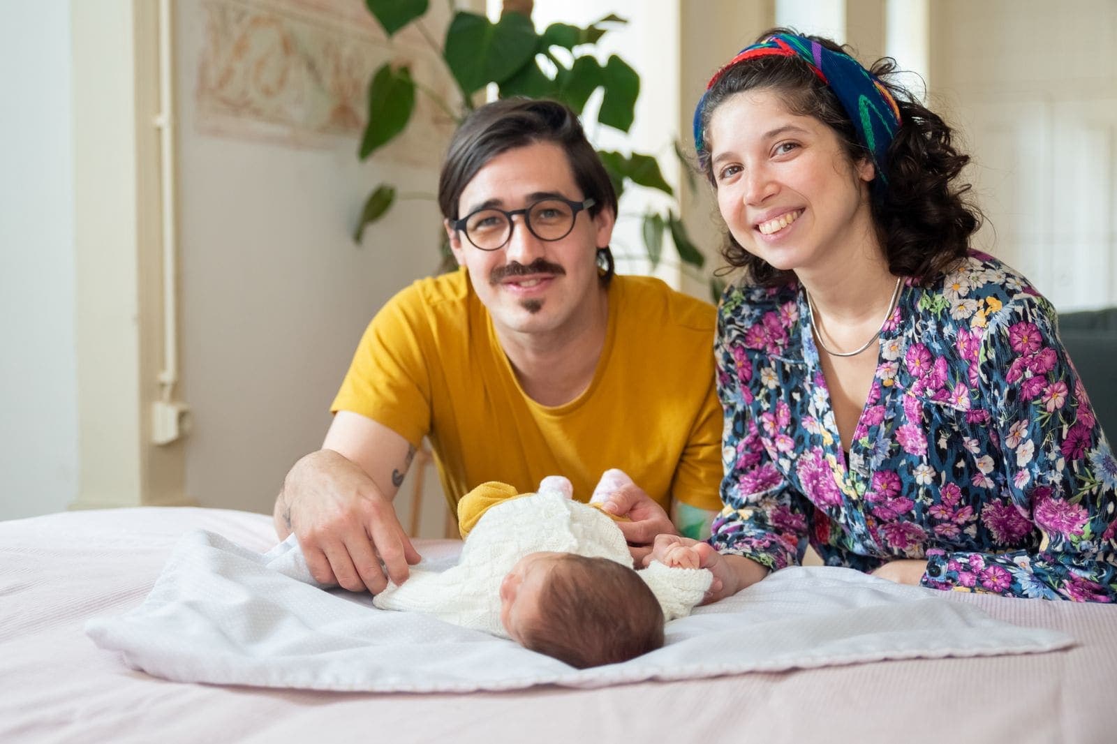 New parents holding their newborn baby
