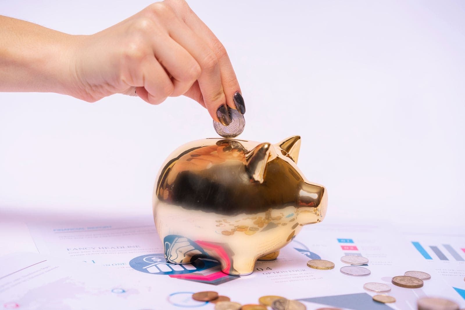 A piggy bank beside a stack of coins