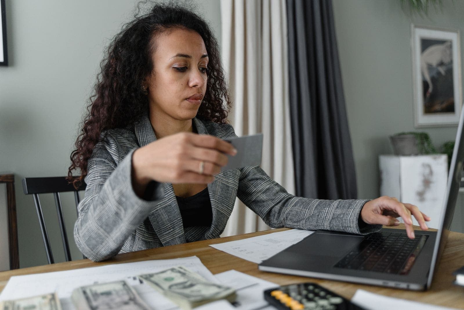 A woman paying bills on her laptop at home