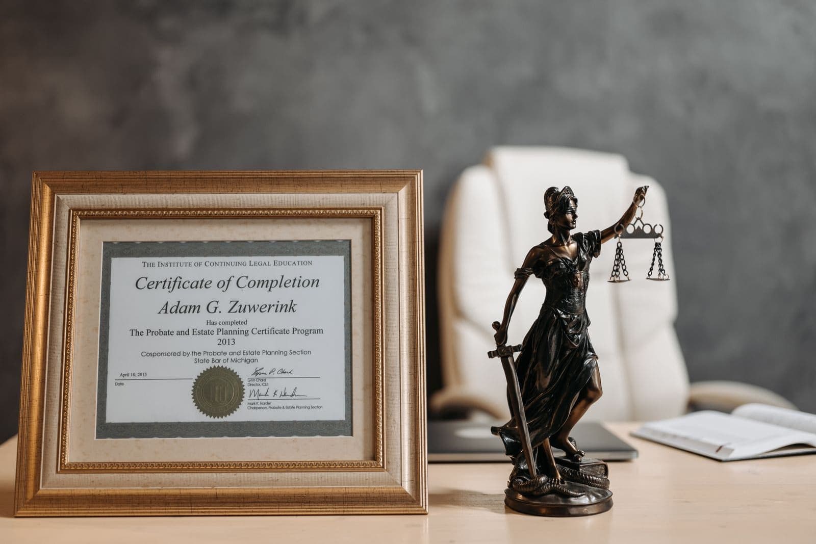 A framed professional certificate hanging in an office