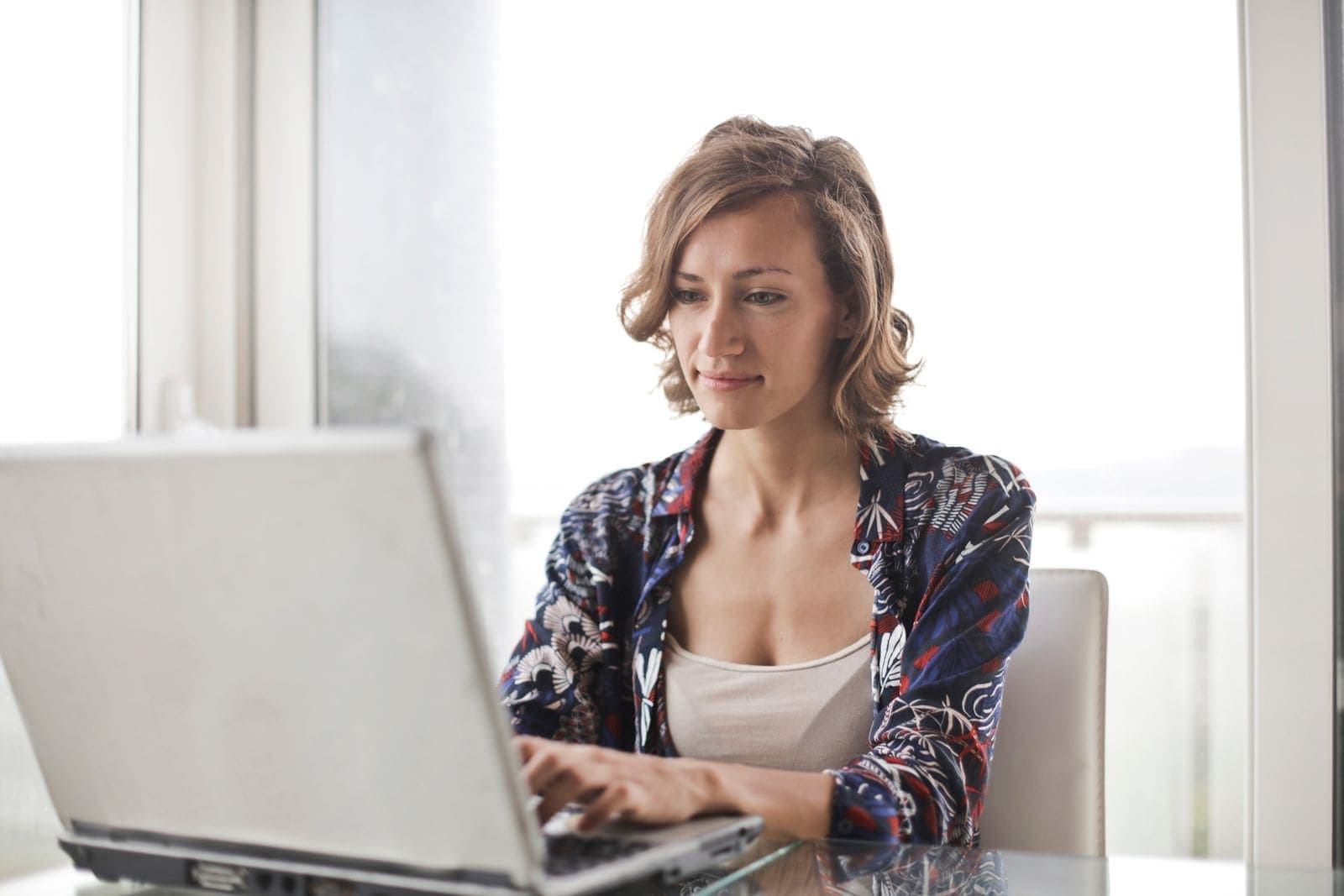 A person typing on a laptop at home