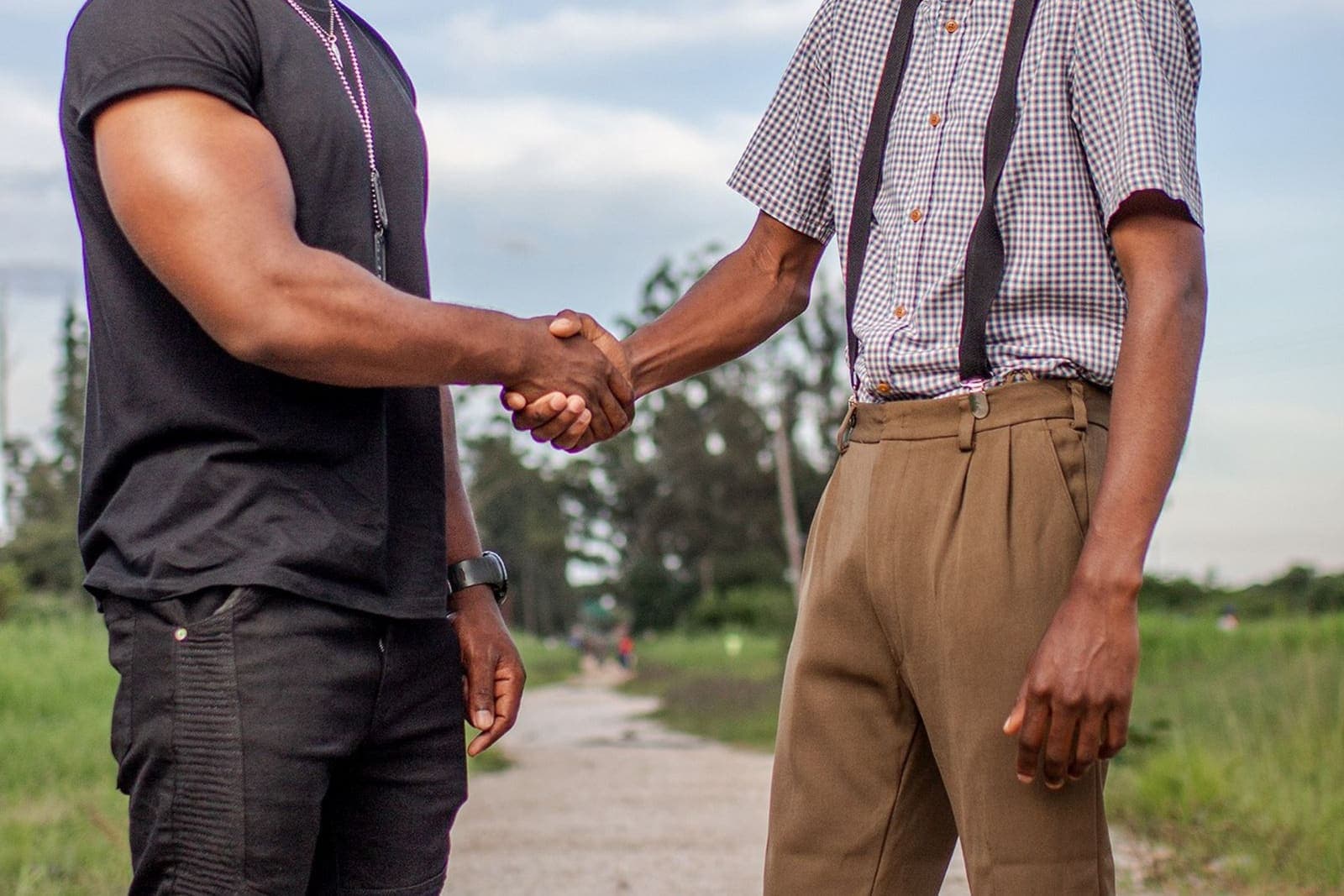 Two people shaking hands across a desk